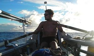 man rowing on sea