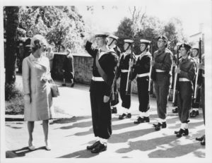 1971 Margaret Thatcher and a saluting CCF member dressed in navy uniform