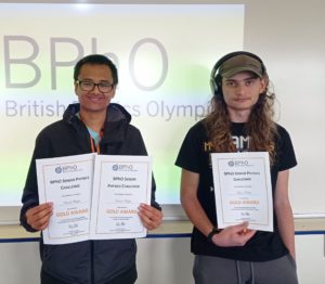 Daniel and Adam holding their certificates