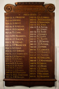 Wooden Board with gold lettering listing past OCA Presidents