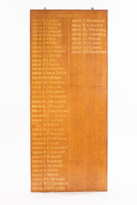 Wooden board with gold lettering with the names of past OCA Presidents