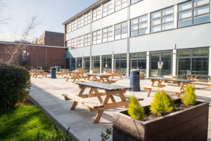 outside photo of picnic benches and plants