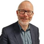 smiling man wearing glasses
